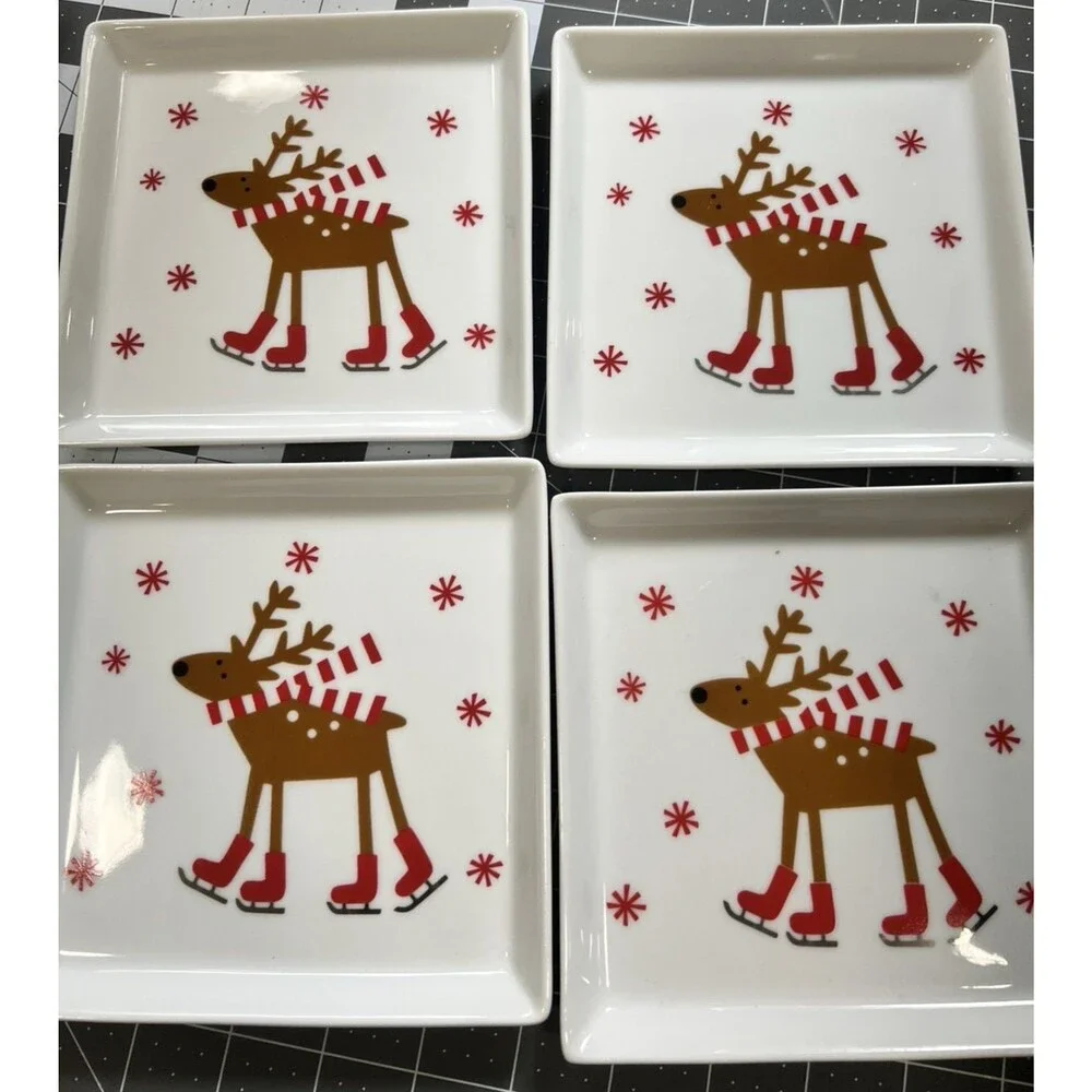CRATE & BARREL SKATING REINDEER CHRISTMAS 4 plates christmas